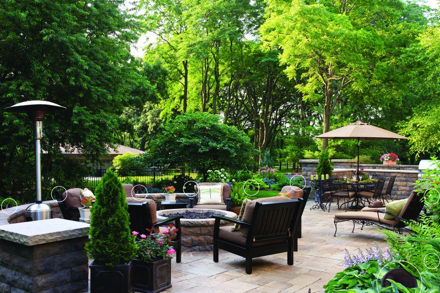 A backyard patio. Outdoor speakers are circled to highlight their locations in the yard.